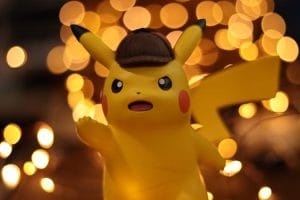 A close-up of a Pikachu figurine illuminated by a warm bokeh effect, creating an eye-catching visual. Mission Impossible Camp