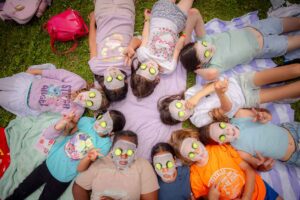 girls layout out with face masks and cucumbers at day spa retreat camp