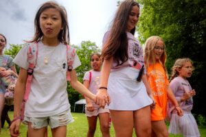a group of girls walking with a camp leader
