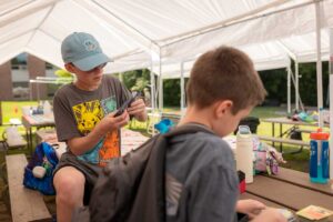 boys playing Pokemon at camp mirage