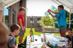 kids at camp building a lego tower