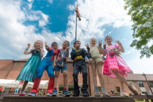 group of kids dressed up as superheroes and princess at camp